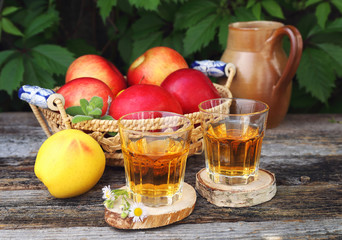Apple juice in two glass on old wooden table