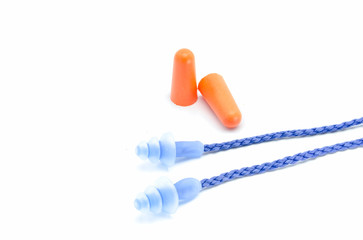 Blue and orange earplugs with a string on white background.