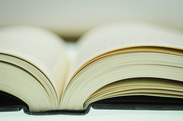 Book Binding - ECU / Extreme close-up of book binding, open on tabletop