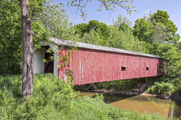 Built in 1854, Cades Mill Covered Bridge crosses Coal Creek in rural Fountain County, Indiana.