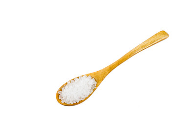white crystals sea salt on wooden spoon on white background, top view