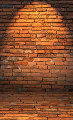 Low key photo of red brick wall with lighting effect. dark toned color of red brick wall. old and...