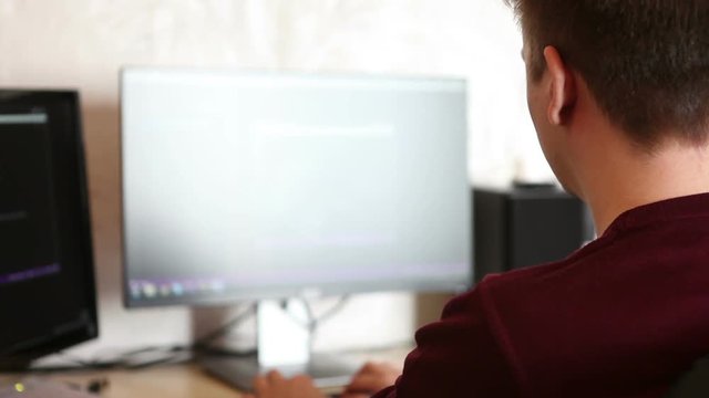 Man programmer working on a program code