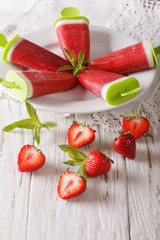 Fruit strawberry ice lolly close up on a plate. Vertical
