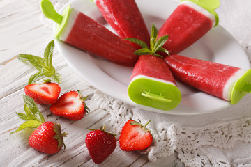 Fruit strawberry ice lolly close up on a plate. horizontal
