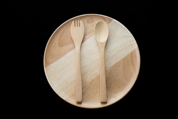 close up wooden dish ,spoon and fork on black background. top view