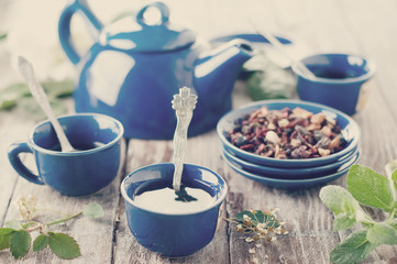 Tea being poured into cup. Toned photo