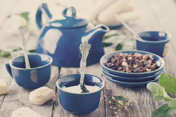 Tea being poured into cup. Toned photo