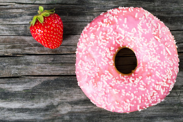 Donut with Strawberry Icing on white dish. close-up