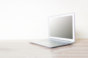 Computer laptop on wooden table with soft  background