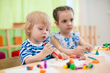 Kids doing arts and crafts. Children in kindergarten.