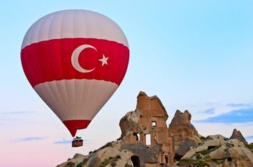 Hot air balloons over mountain landscape in Cappadocia, Turkey