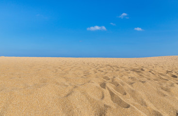Fototapeta na wymiar Empty tropical beach with white cloud and blue sky background in Thailand