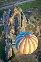 Hot air balloons over mountain landscape in Cappadocia, Turkey