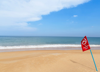 warning red flag no swimming sign on the beach 