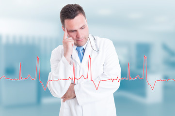 Thoughtful young doctor with heartbeat graph on screen
