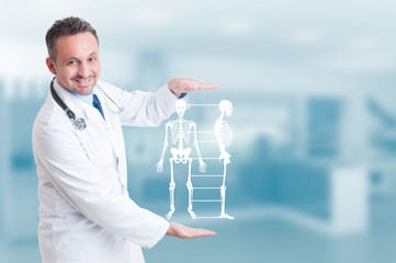 Handsome orthopedist doctor holding skeleton model hologram on h