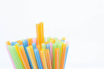 Fototapeta premium Colorful plastic straws used for drinking water or juices on whi
