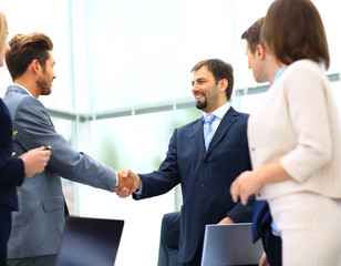 Business colleagues sitting at a table during a meeting with two