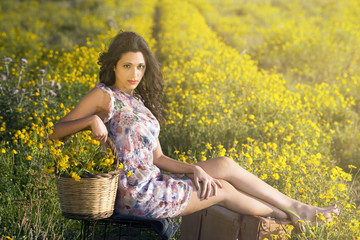Naklejka na ściany i meble fashion woman sitting in a field intense gaze
