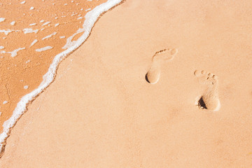 Abstract sand background with tracks of feet