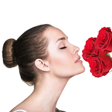 Attractive Young Woman Smelling Roses