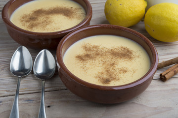 Traditional creme brulee on ceramic dish on wooden table