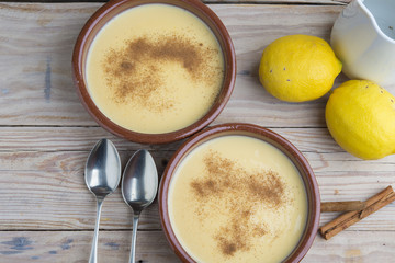 Traditional creme brulee on ceramic dish on wooden table
