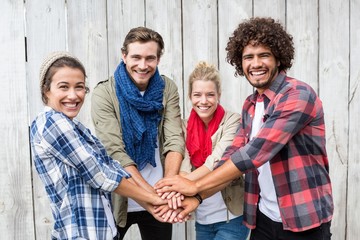 Friends putting their hands together