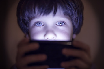 Small child playing on a smartphone