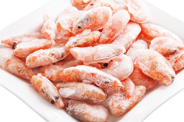 Frozen shrimps on a square dish, isolated on white