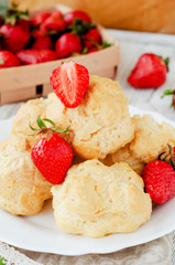 
dessert with berries , custard eclairs or cakes with cream and red strawberries on a wooden background