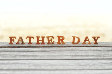 Happy father day concept, word of wooden father day on wood on beach background idea