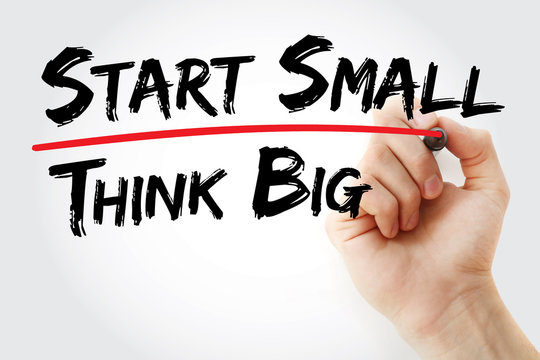 Hand writing Start small think big with red marker, business concept