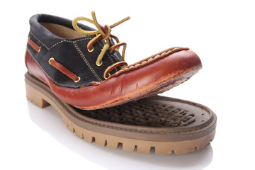 torn shoe on a white background isolate.