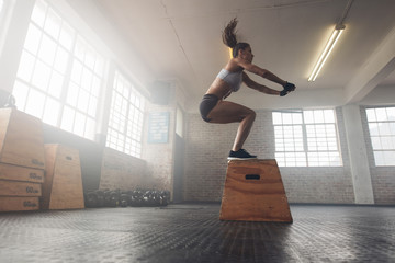 Woman doing a box squat at the gym