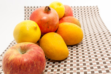 Ripe yellow and red colored mango fruits on mat background