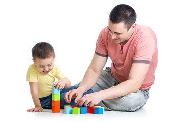 Dad and son kid playing construction game together