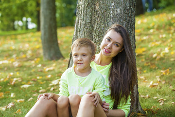 Young Mother and son playing in summer park