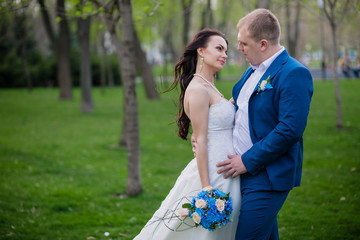 Bride and Groom at wedding Day walking Outdoors on spring nature.
