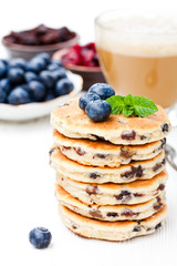 Stack  of welsh cakes with blueberry and a cup of coffee