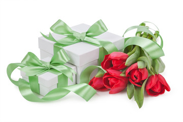 boxes with green ribbons and a bouquet of tulips isolated.