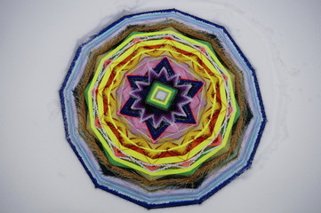 photo of a handmade Native American mandala in the winter on a snow