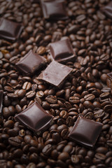 Coffee beans with chocolate on wooden background