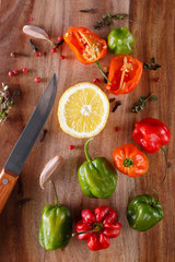 fresh peppers of different colors on a wooden board. burning spices. Background of fresh vegetables. view from above. flat lay.