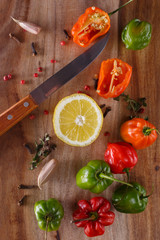 still life. painting vegetables.fresh peppers of different colors on a wooden board. burning spices. Background of fresh vegetables. view from above. flat lay.