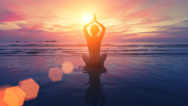 Woman Yoga Silhouette On The Beach At Amazing Sunset.