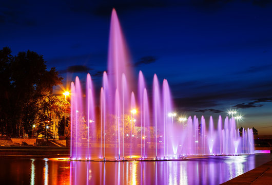 illuminated in different colors at night fountains Plotinka. Summer Yekaterinburg downtown.