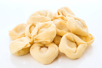 uncooked tortellini isolated on white