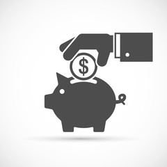 Hand puts a coin to piggy